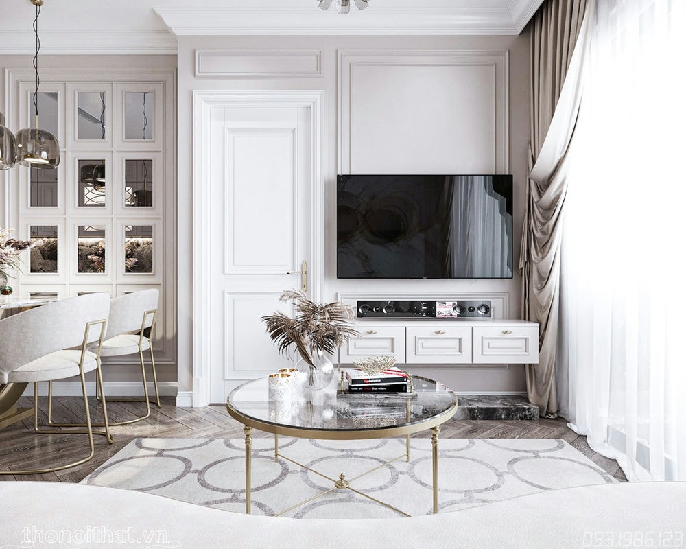 Đối diện với bộ sofa vẫn là chiếc bàn tròn và kệ tivi được sử dụng rất đơn giản và nhẹ nhàng