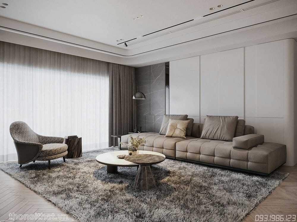 Bộ sofa màu nâu sữa được thiết kế rất ấn tượng theo hình chữ I dọc theo mé tường trắng