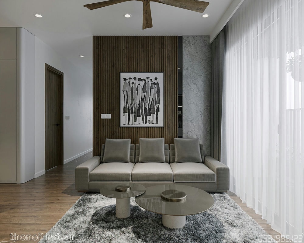 Chiếc kế sofa rất đơn giản với chiếc bàn tròn cùng tone màu nâu xám đặt trên thảm lông chuột